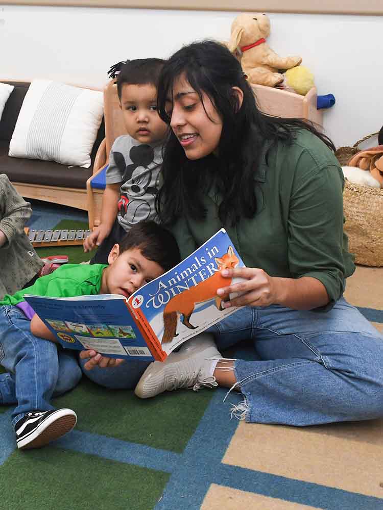 Early childhood instructor supporting child growth through interactive play