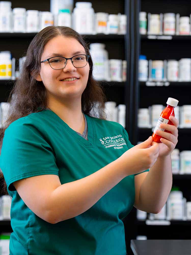 pharmacy tech posting with medicine bottle
