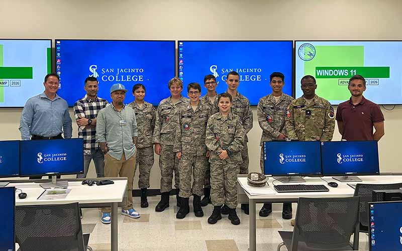Group photo of CyberPatriot camp students with San Jacinto College staff in Security Operations Center
