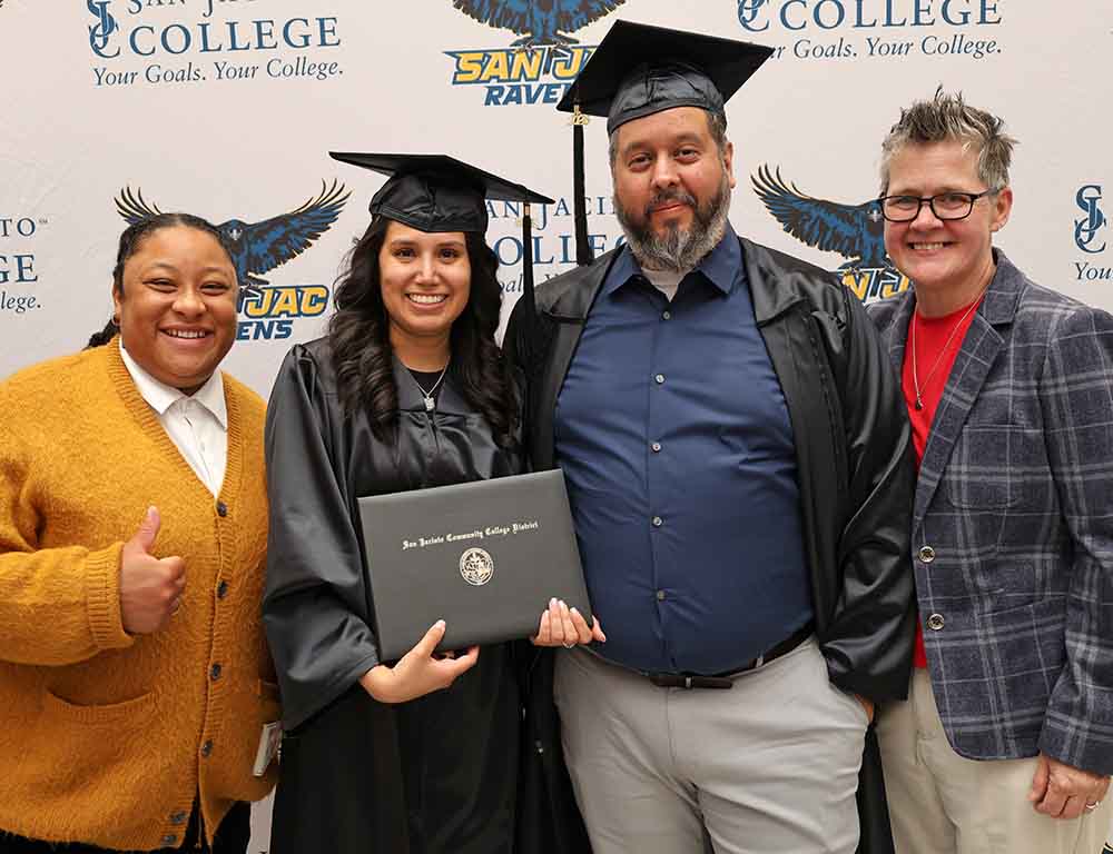 Two Opportunity High School diploma graduates posing with their two instructors